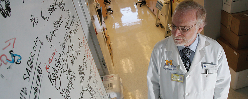 Max Wicha, M.D. studies the white board in his laboratory