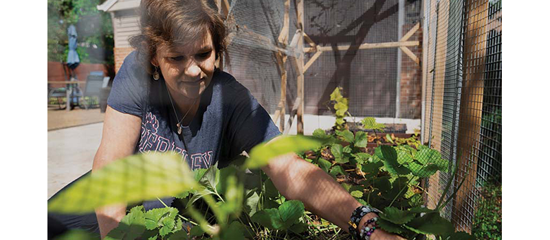 Lori Robertson gardening in her front yard