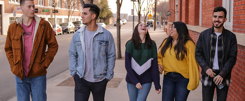 A group of twenty-something men and women walking together